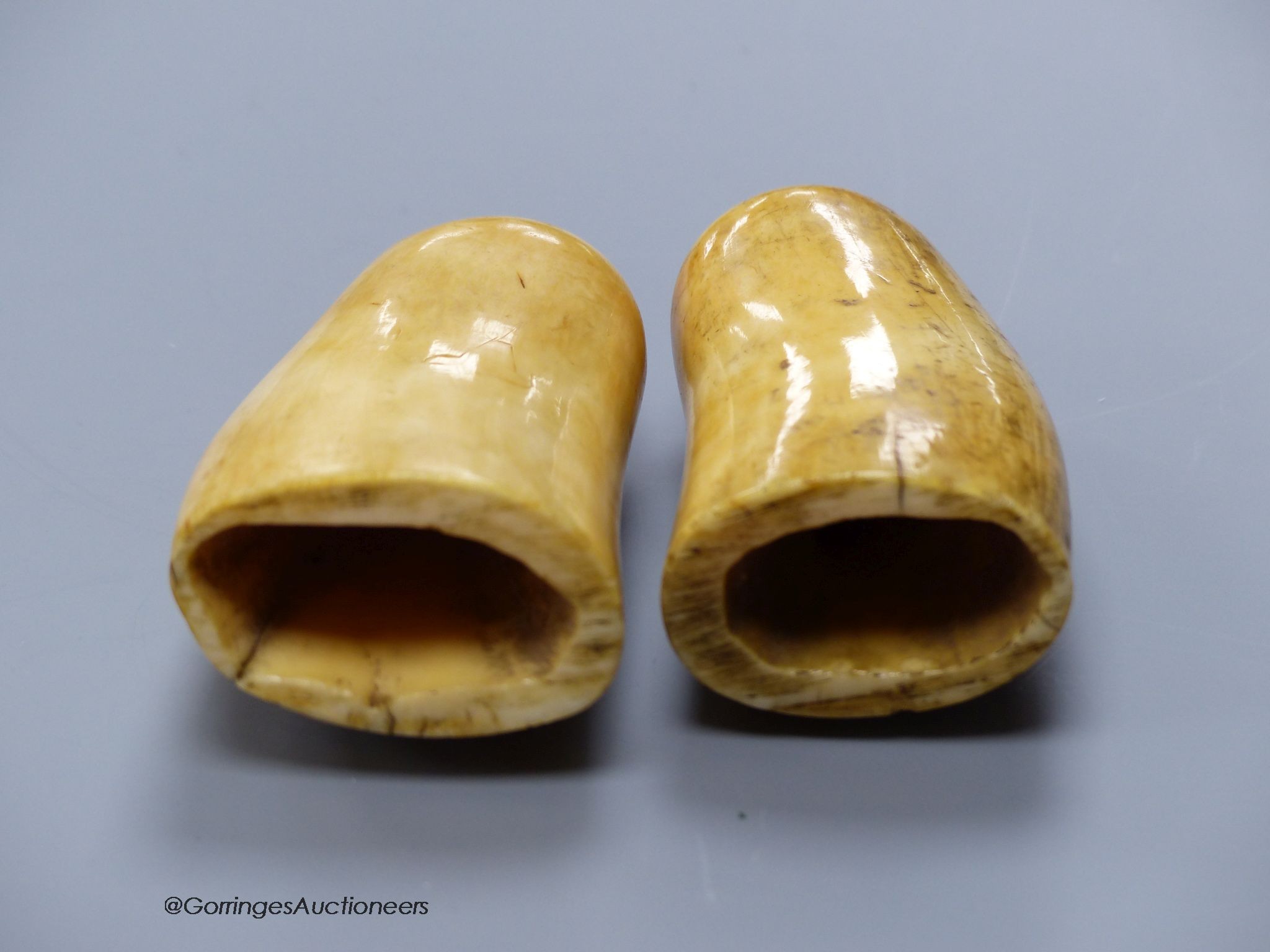 Two 19th century scrimshaw sperm whale teeth, engraved with Victorian figures, height 10cm